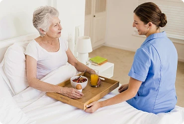 A professional home care worker looks after an elderly woman.