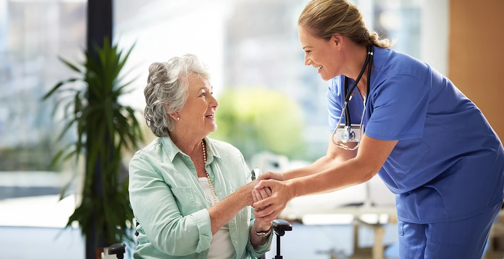 A professional home care worker looks after an elderly woman