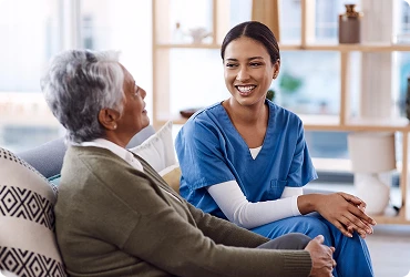 A professional home care worker looks after an elderly woman