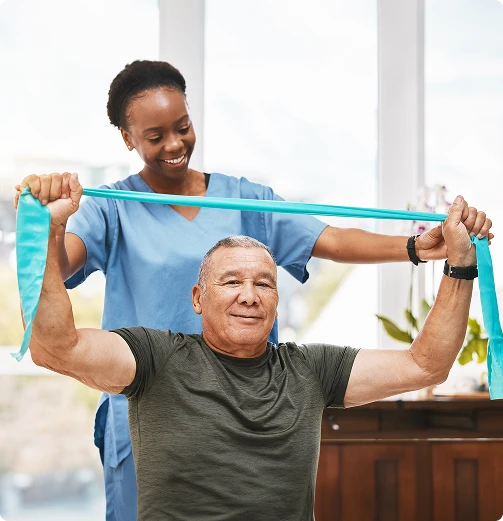 Smiling female physiotherapist helps older man with turquoise resistance band