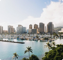 Honolulu waterfront skyline with high-rise buildings and a marina full of boats